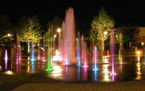 Lit fountains at night in Elgin, IL
